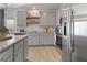 Modern kitchen featuring gray cabinetry, granite countertops, and stainless steel appliances at 225 Ivey Ter, Temple, GA 30179