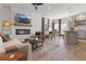 Open-concept living space features a fireplace, comfortable seating, and a view of the kitchen area at 225 Ivey Ter, Temple, GA 30179