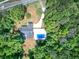 Stunning aerial view of a secluded home with a large in-ground pool surrounded by lush greenery at 2652 Mount Tabor Church Rd, Dallas, GA 30157
