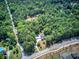 Expansive aerial view of property showcasing a secluded home with an in-ground pool nestled among dense trees at 2652 Mount Tabor Church Rd, Dallas, GA 30157