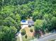 Aerial view of home featuring a pool and deck, all surrounded by trees for a private setting at 2652 Mount Tabor Church Rd, Dallas, GA 30157