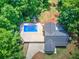 Aerial view of backyard with in-ground pool and concrete patio, featuring an adjacent lush tree line at 2652 Mount Tabor Church Rd, Dallas, GA 30157