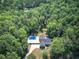 Aerial view of the property surrounded by lush greenery, highlighting the pool at 2652 Mount Tabor Church Rd, Dallas, GA 30157