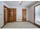 Bedroom showcasing wood trim doors, neutral carpet, and a window, creating a cozy atmosphere at 2652 Mount Tabor Church Rd, Dallas, GA 30157