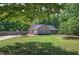 Exterior of the house with a large front yard featuring a well-maintained lawn and a private driveway at 2652 Mount Tabor Church Rd, Dallas, GA 30157