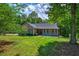Charming single-story home with a welcoming front porch and manicured lawn and professional landscaping at 2652 Mount Tabor Church Rd, Dallas, GA 30157