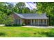 Well-maintained home featuring a covered front porch, lush lawn, and attractive landscaping at 2652 Mount Tabor Church Rd, Dallas, GA 30157