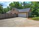 Attached two-car garage with wide driveway nestled among lush trees, providing ample parking at 2652 Mount Tabor Church Rd, Dallas, GA 30157