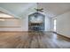 Inviting living room with stone fireplace, ceiling fan, light hardwood floors, and natural light at 2652 Mount Tabor Church Rd, Dallas, GA 30157