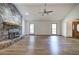 Open living room featuring hardwood floors, a stone fireplace, and vaulted ceilings at 2652 Mount Tabor Church Rd, Dallas, GA 30157