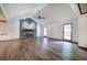 Spacious living room featuring a stone fireplace, wood floors, and natural light from two windows at 2652 Mount Tabor Church Rd, Dallas, GA 30157
