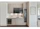 Modern bar area includes a sink, cabinets, beverage fridge, and wine storage at 3107 Peachtree Ne Rd # 1005, Atlanta, GA 30305
