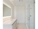 Sleek bathroom featuring a glass shower, backlit mirror, and double sink vanity; a luxurious and functional space at 3107 Peachtree Ne Rd # 1005, Atlanta, GA 30305