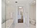 Bright bathroom featuring a soaking tub, walk-in shower, and access to walk-in closet at 3107 Peachtree Ne Rd # 1005, Atlanta, GA 30305