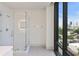 Modern bathroom with glass-enclosed shower and floor to ceiling city views at 3107 Peachtree Ne Rd # 1005, Atlanta, GA 30305