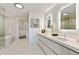 Bright bathroom boasts double vanity sinks, a soaking tub, and modern fixtures at 3107 Peachtree Ne Rd # 1005, Atlanta, GA 30305