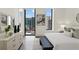 Bedroom with city views, light-colored hardwood floors, and decorative accents at 3107 Peachtree Ne Rd # 1005, Atlanta, GA 30305