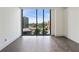 Bedroom with floor to ceiling windows, dark hardwood flooring, and white walls at 3107 Peachtree Ne Rd # 1005, Atlanta, GA 30305