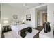 Well-lit bedroom featuring a queen-size bed, decorative art, and a bench at 3107 Peachtree Ne Rd # 1005, Atlanta, GA 30305