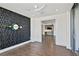 Bedroom featuring a geometric accent wall, hardwood floors, and a doorway to another room at 3107 Peachtree Ne Rd # 1005, Atlanta, GA 30305