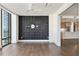 Bedroom with a dark geometric wall, hardwood flooring, and a doorway to the kitchen at 3107 Peachtree Ne Rd # 1005, Atlanta, GA 30305