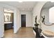 Bright entryway featuring hardwood floors, a round mirror, and a glimpse into the bathroom with a modern vanity at 3107 Peachtree Ne Rd # 1005, Atlanta, GA 30305