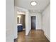 Hallway with wood floors leading to a bathroom and entryway at 3107 Peachtree Ne Rd # 1005, Atlanta, GA 30305