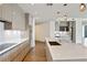 Kitchen with large island, modern appliances, designer lighting, and seamless cabinetry at 3107 Peachtree Ne Rd # 1005, Atlanta, GA 30305