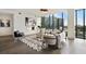 Bright living room with floor-to-ceiling windows offers city views and hardwood flooring at 3107 Peachtree Ne Rd # 1005, Atlanta, GA 30305