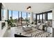 Bright living room with modern furnishings and a floor to ceiling window overlooking a city view at 3107 Peachtree Ne Rd # 1005, Atlanta, GA 30305