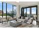 Bright living room boasts floor-to-ceiling windows with city views, modern furniture, and stylish chevron rug at 3107 Peachtree Ne Rd # 1005, Atlanta, GA 30305
