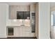 Modern wet bar features custom cabinetry, stone countertops, and beverage cooler at 3107 Peachtree Ne Rd # 1005, Atlanta, GA 30305