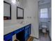 Bathroom featuring a vanity with double sinks and blue cabinets at 5687 Highway 212, Covington, GA 30016