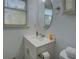 This bathroom has a vanity with a white countertop and a window at 5687 Highway 212, Covington, GA 30016