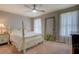 This is a bedroom with a four-poster bed, ceiling fan and neutral walls at 5687 Highway 212, Covington, GA 30016