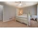 Bedroom featuring a four-poster bed, ceiling fan and neutral walls at 5687 Highway 212, Covington, GA 30016