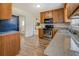 Functional kitchen with stainless steel appliances, laminate floors, and granite countertops at 5687 Highway 212, Covington, GA 30016