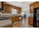Well-lit kitchen with wooden cabinets, stainless steel appliances, and an adjacent office area at 5687 Highway 212, Covington, GA 30016