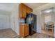View of kitchen area with stainless steel appliances and wooden cabinets, leading to dining area at 5687 Highway 212, Covington, GA 30016