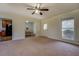 Large living room offering seamless access to the dining area and kitchen, featuring neutral decor and carpeting at 5687 Highway 212, Covington, GA 30016