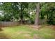 Spacious backyard with lush green grass, wooden fencing, and mature trees, providing a serene outdoor space at 1026 Lester Se Ave, Atlanta, GA 30316