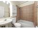 Standard bathroom design with sink, toilet, and bathtub shower combo, featuring tiled walls at 1026 Lester Se Ave, Atlanta, GA 30316