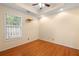 Bedroom featuring hardwood floors, tray ceiling, and a window that brightens the room with natural light at 1026 Lester Se Ave, Atlanta, GA 30316