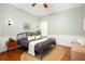 Cozy bedroom with a ceiling fan, hardwood floors, and a vintage-style bed frame at 1026 Lester Se Ave, Atlanta, GA 30316