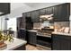 Modern kitchen with stainless steel appliances, granite countertops, and dark cabinets at 1026 Lester Se Ave, Atlanta, GA 30316