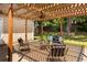 Inviting backyard patio with comfortable seating beneath a pergola, perfect for outdoor relaxation and entertaining at 1026 Lester Se Ave, Atlanta, GA 30316