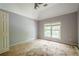 Bedroom with a high ceiling, a large window, and a closet. Ready for renovation at 425 Fieldstone Lndg, Alpharetta, GA 30005