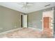 Bedroom with an open closet and doorway; ceiling fan, natural light. Renovation project at 425 Fieldstone Lndg, Alpharetta, GA 30005