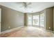Bedroom with bay windows, ready for renovation. Featuring ceiling fan; awaits transformation at 425 Fieldstone Lndg, Alpharetta, GA 30005