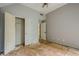 Bedroom featuring a large closet and doorway, illuminated by a ceiling fan. Awaits remodel at 425 Fieldstone Lndg, Alpharetta, GA 30005